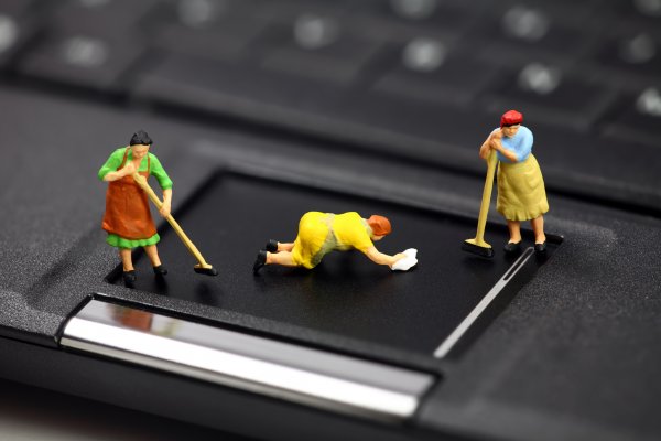 registry cleaners regclean pro toy figurines cleaning people on black laptop pad